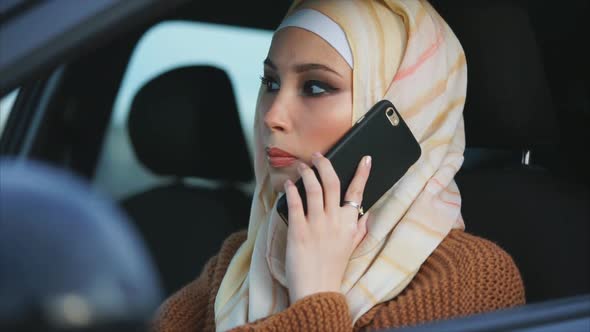 Modern Muslim Woman Having a Mobile Phone Talk and Going To Travel By Car