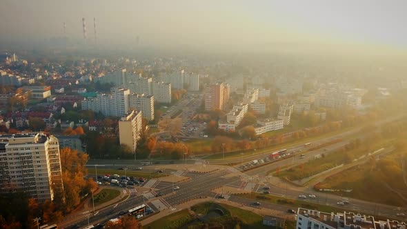 Beautiful cinematic aerial shot of misty sunrise in foggy town in autumn