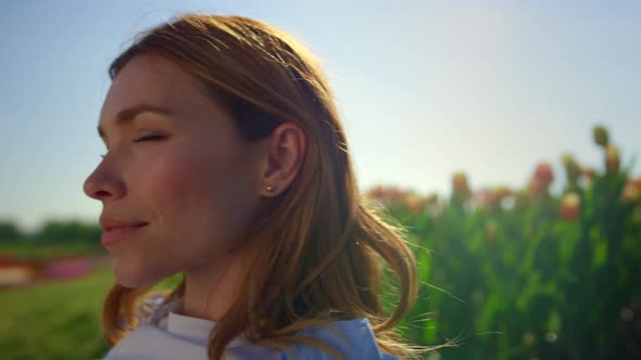 Happy Woman Enjoying Summer Sunshine on Green Grass