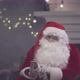 Santa Claus Sitting on Couch and Talking on Smartphone - VideoHive Item for Sale