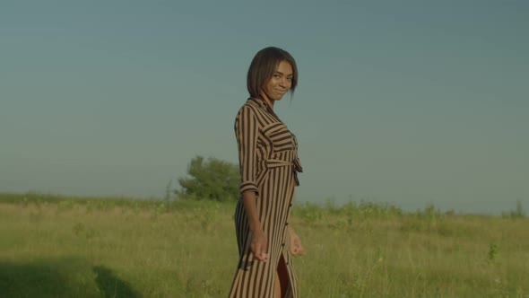 Lovely African American Woman Inviting to Follow with Hand Gesture in Nature