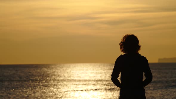 Woman Walking On Beach At Morning.