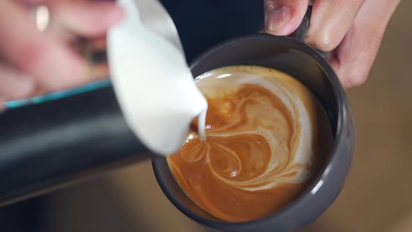 4K Close up barista hand making coffee latte in coffee cup