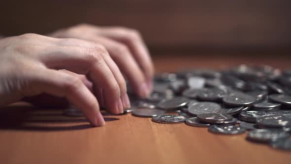 women's hands count coins