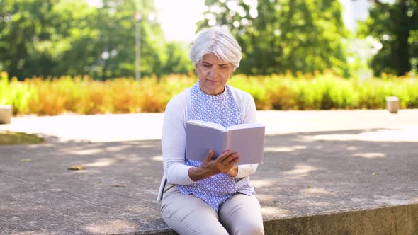 Senior Woman Reading Book at Summer Park 16