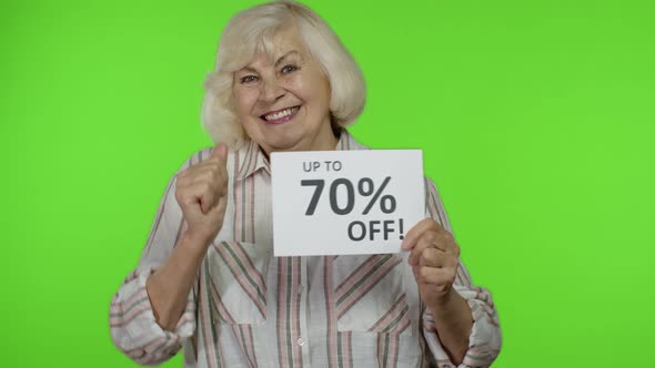 Senior Grandmother Showing Up To 70 Percent Off Inscription Sign, Rejoicing Discounts. Chroma Key