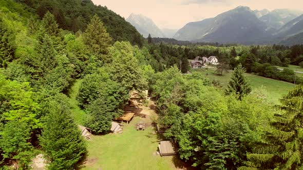 Aerial view of summer camp with small camping cabins and recreational area.