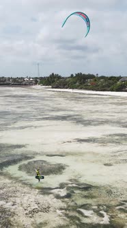 Vertical Video Kitesurfing Near the Shore of Zanzibar Tanzania