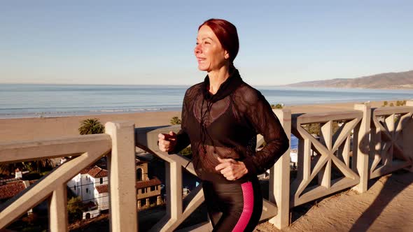 Mature Woman Exercising At The  Beach