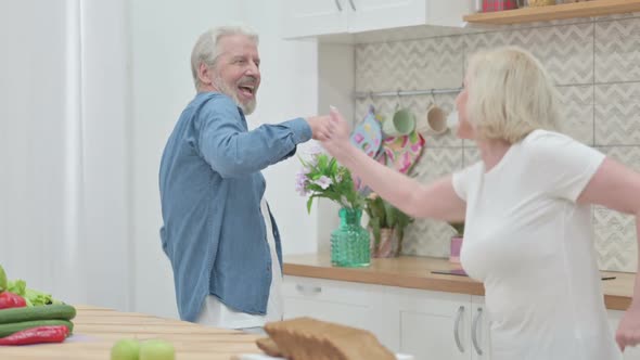 Old Couple Dancing in Kitchen