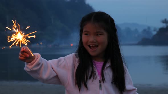 Girl with sparkler on Fourth of July