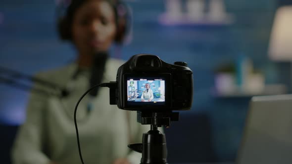 Close Up of Professional Camera Sitting in Front of Dslr Recording