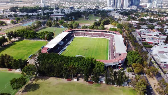 Soccer players training in an empty stadium.