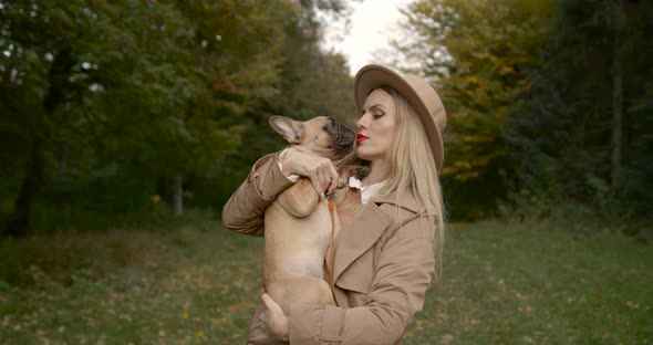 Woman with a French Bulldog in the Autumn Forest