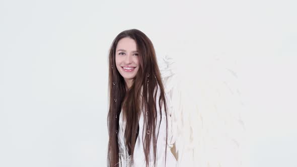 Girl in White Dress with Angel Wings on White Background