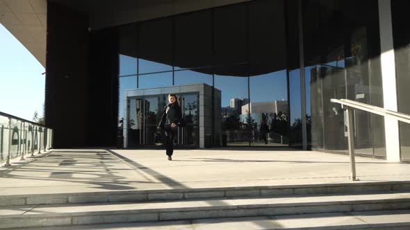 Young Girl Nervous Runs Out of Business Center, She Is Late for a Meeting