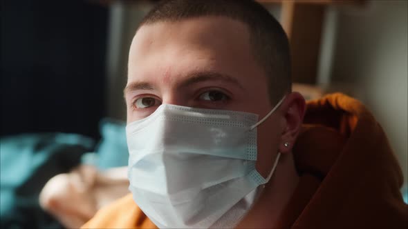 Portrait of Young American Man Face Wearing Medical Surgical Mask to Protect Coronavirus Covid 19