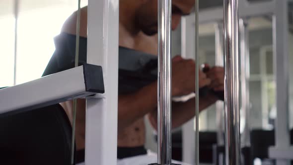 Man Exercising His Abs Muscles with Press Machine at the Gym