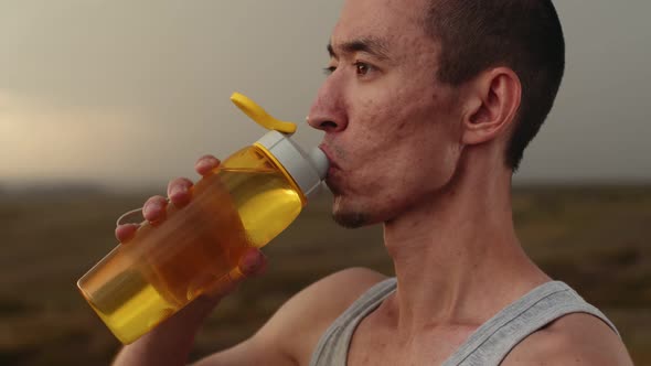 Athlete Drinks Water From Bottle After Training Closeup Side View Slow Motion Runner After Training