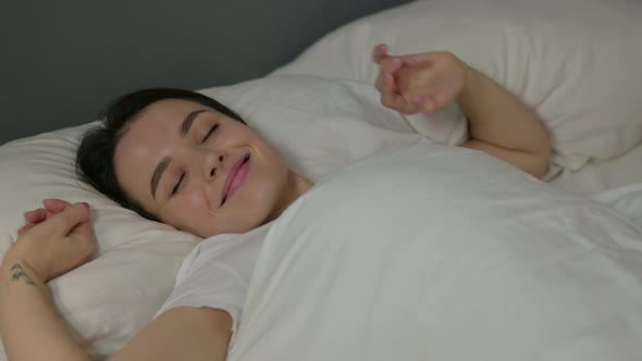 Young Woman Waking Up From Sleep in Bed 