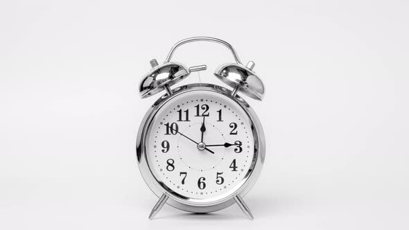 Time lapse of retro alarm clock running isolated on white background. T