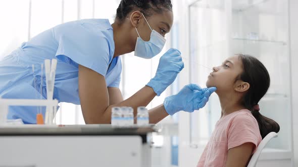 Crop View of Medical Female Worker in Protective Mask and Gloves Taking PCR Test Sample From Little