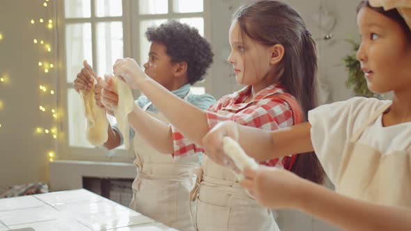 Children Stretching Dough at Cooking Class