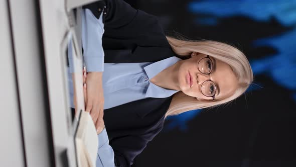 VERTICAL VIDEO POV Portrait of Focused Young Business Woman in Suit Posing at Hi Tech Office