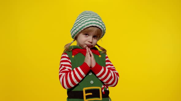 Kid in Christmas Elf Santa Helper Costume Begs Prays About Gifts on New Year