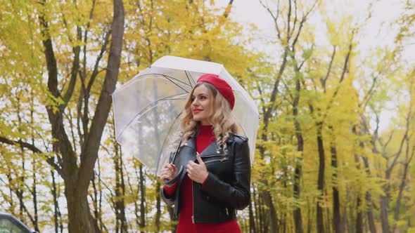 Beautiful Blonde Woman Walking in the Autumn Park with Umbrella