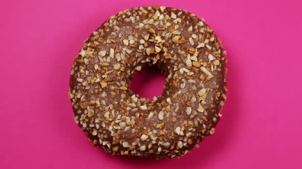 Donut with White Icing on an Pink Background