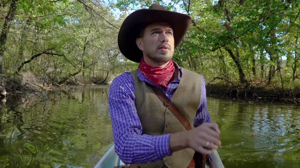 Cowboy in a Canoe Floats on the River