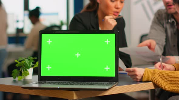 Laptop with Green Screen Ready for Presentation Placed on Desk