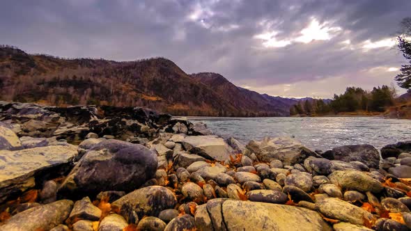 Time Lapse Shot of a River Near Mountain Forest. Huge Rocks and Fast Clouds Movenings. Horizontal