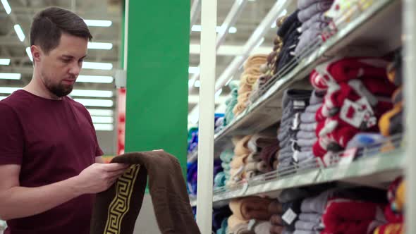 Shopper is Taking Towels From Shelf in Sale Hall of Shop