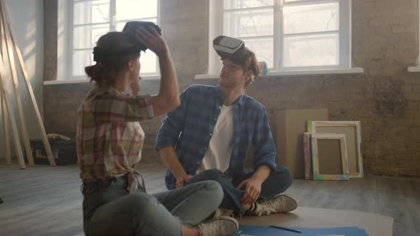 Family in Vr Glasses Sitting on Floor During Home Repair