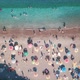 Aerial Top View of Beach with Sunshade and People Swimming at Beautiful Blue Color Sea - VideoHive Item for Sale