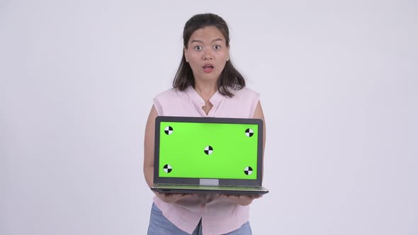 Young Happy Asian Businesswoman Showing Laptop and Looking Surprised