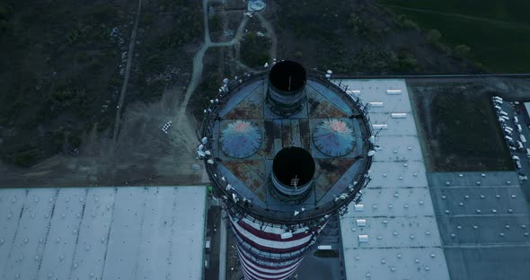 Aerial view, circular camera movement around the idle chimney.