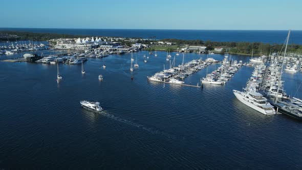 A high panning view of a city marina located inside a protected urban boat harbor on the Gold Coast