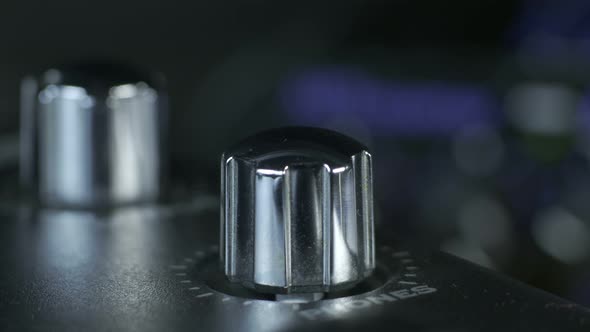 Male Fingers Turning Silver Audio Interface Knob