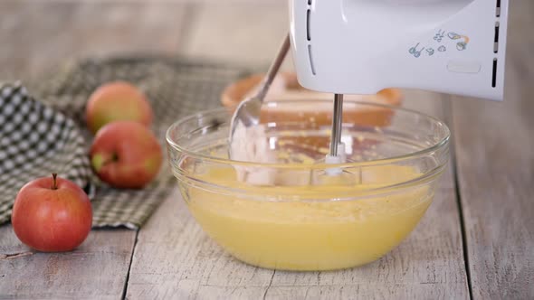 Adding Flour Into Bowl And Mix It With Electric Mixer. Making Apple Cake