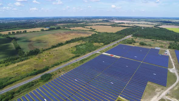 Aerial View of Solar Panels on Green Field in Summer