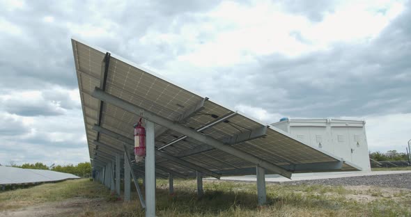 Footage of a Long Row of the Solar Panels Next to a Transformer