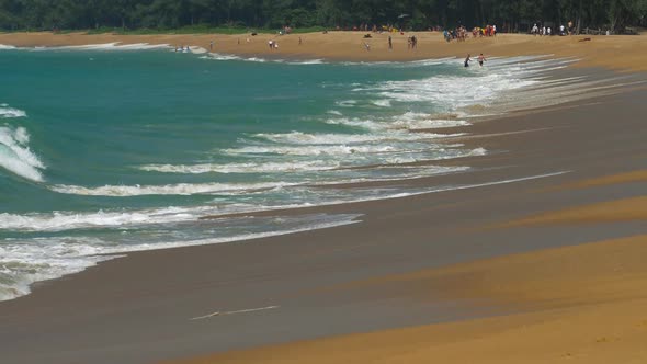 The Tourist on Sand Beach at Mai Khao Beach Near Phuket Airport