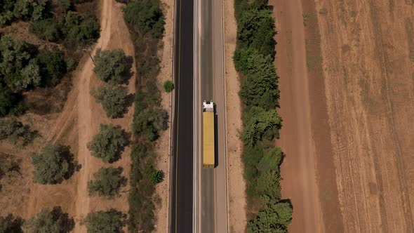 Truck loaded with Shipping container on a rural highway.