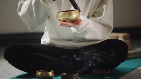 Smoldering Incense and a Woman Conducting a Ritual Before Meditation