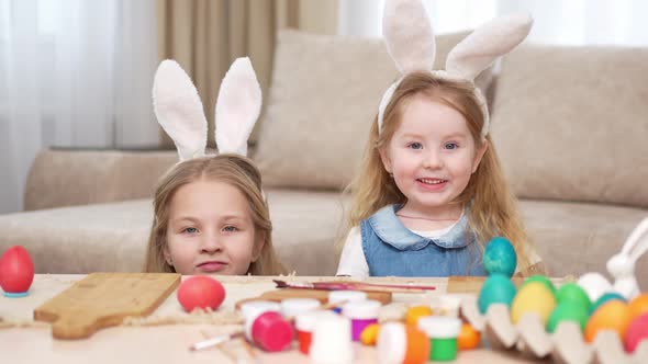 a Happy Little Girls with Rabbit Ears Celebrate Easter and Play Hide and Seek