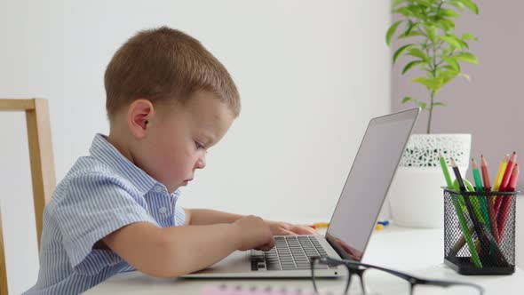 Little Preschooler Boy Learning Online Trying to Type Letters Computer Laptop