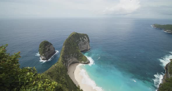 Dolly Tilt Reveal Shot of Stunning Blue Tropical Beach and Peninsula From the Lookout Point